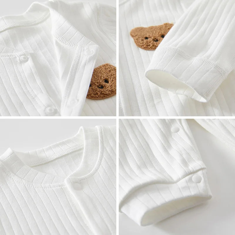 Detailed view of baby romper — snap buttons, stretch cuffs, and soft stitching for baby comfort.