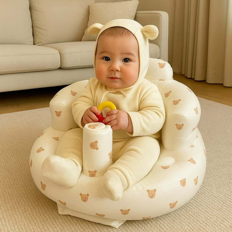 Baby sitting in inflatable baby sit up chair with teddy bear print – soft support seat for infants learning to sit up, perfect baby must have for 2025