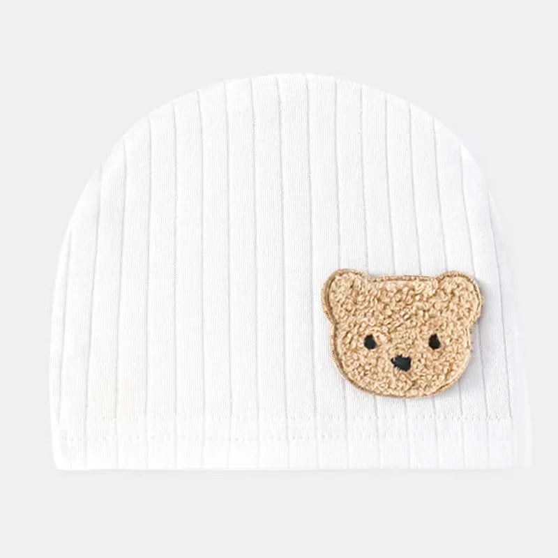 White baby girl beanie hat featuring soft ribbed cotton and teddy bear embroidery